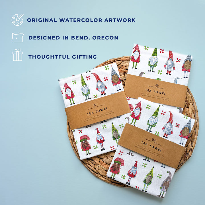 Set of tea towels with gnome design on a woven basket against a light blue background