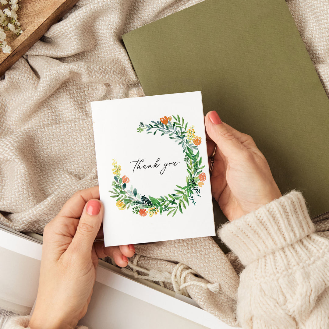 a person holding a thank you card in a box