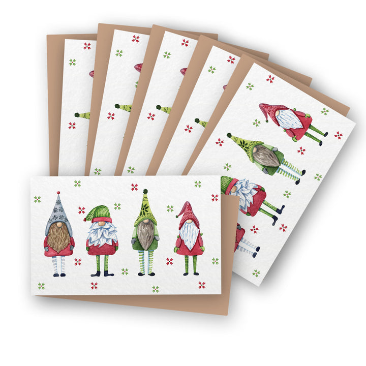 a set of six christmas cards with gnomes on them