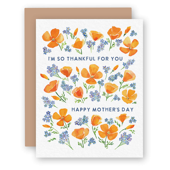 a card with an orange flower and blue flowers on it