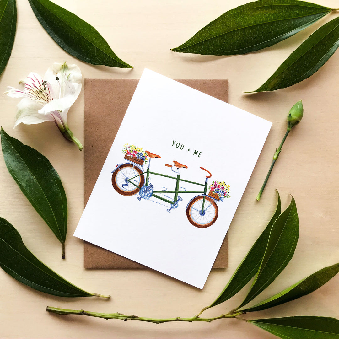 a greeting card with a tandem bicycle on it