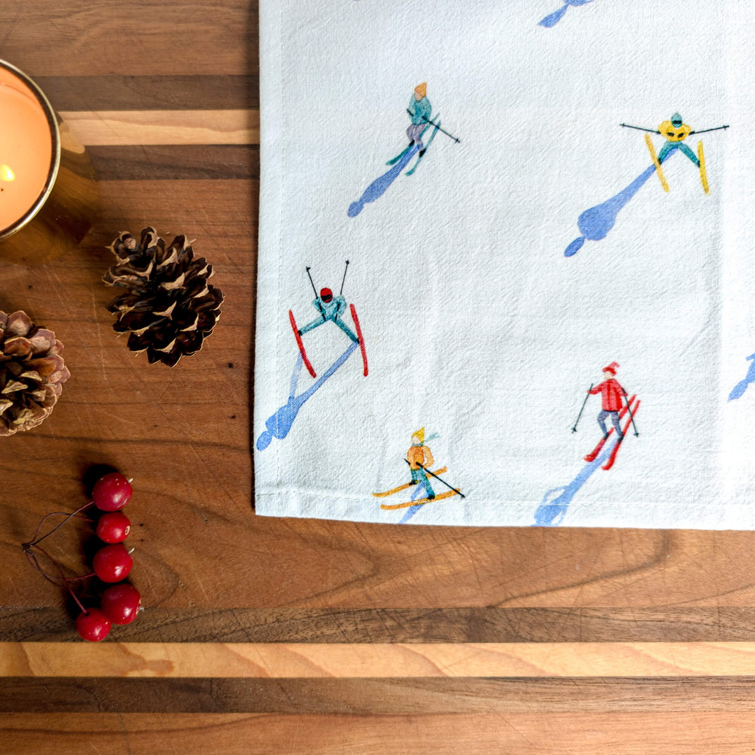 a tea towel with a picture of skiers on it