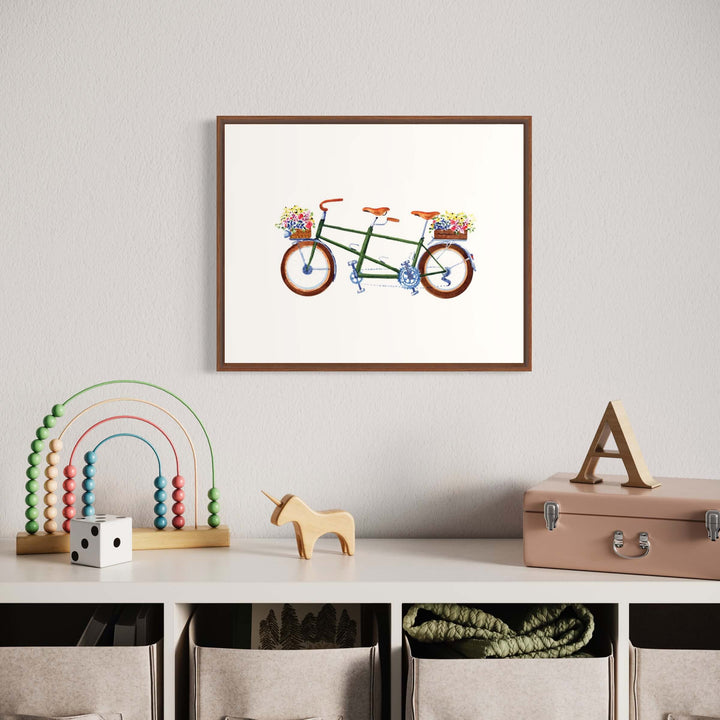 a picture of a bike hanging on a wall in a baby's room