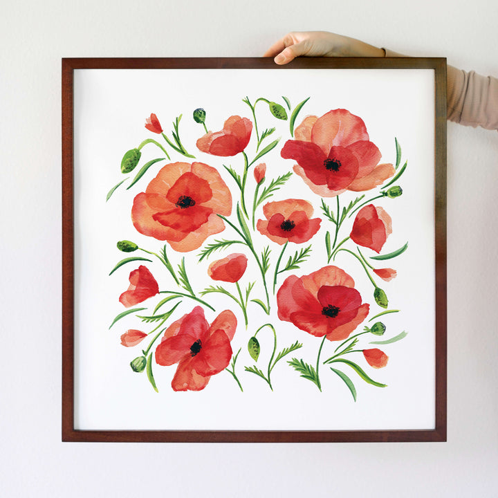 a painting of red flowers on a white wall