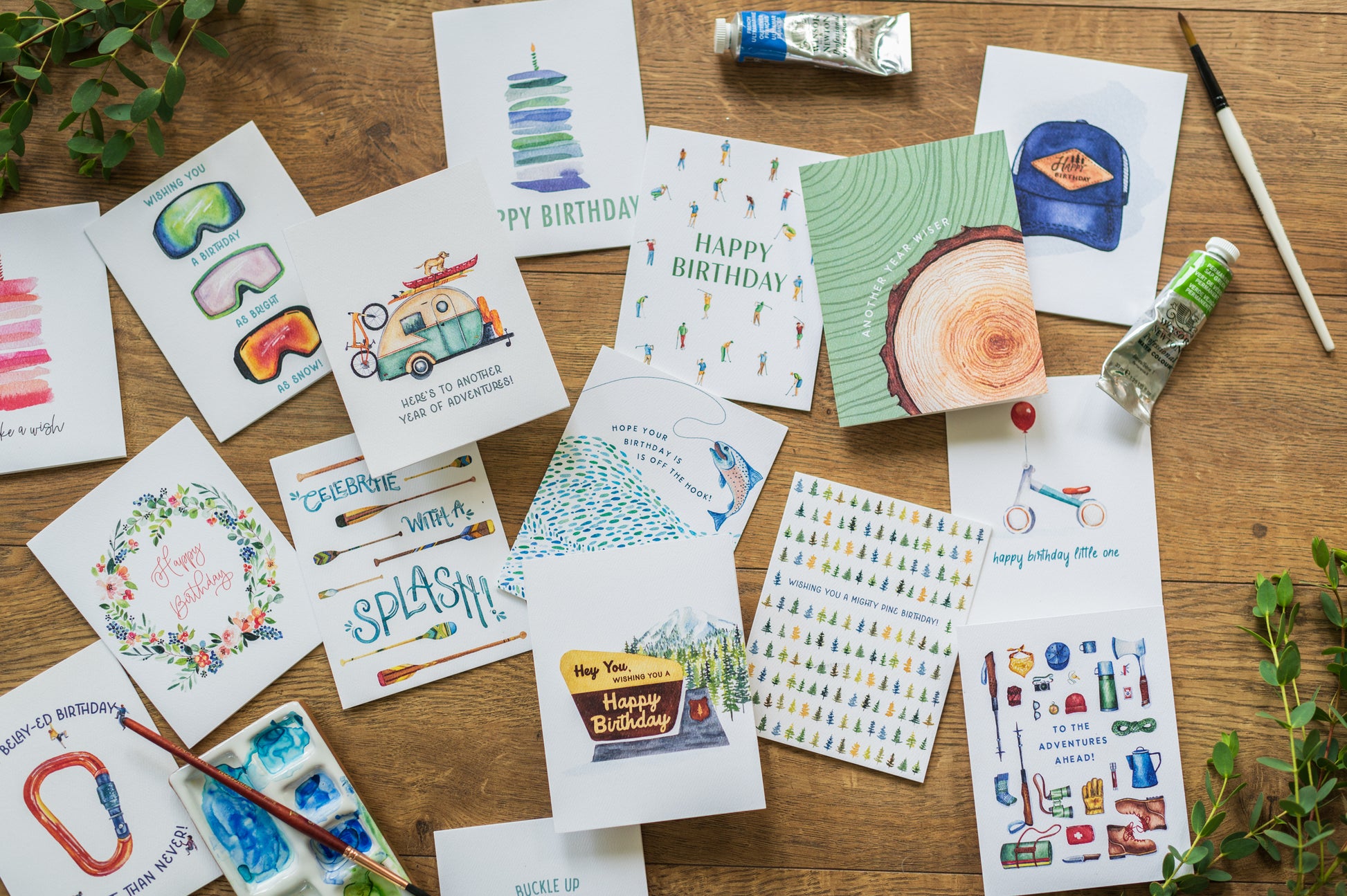 a table topped with lots of different hand painted cards