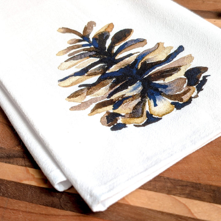 a napkin with a picture of a pine cone on it