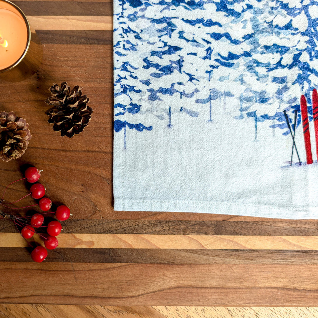 a wooden table topped with a candle and a towel