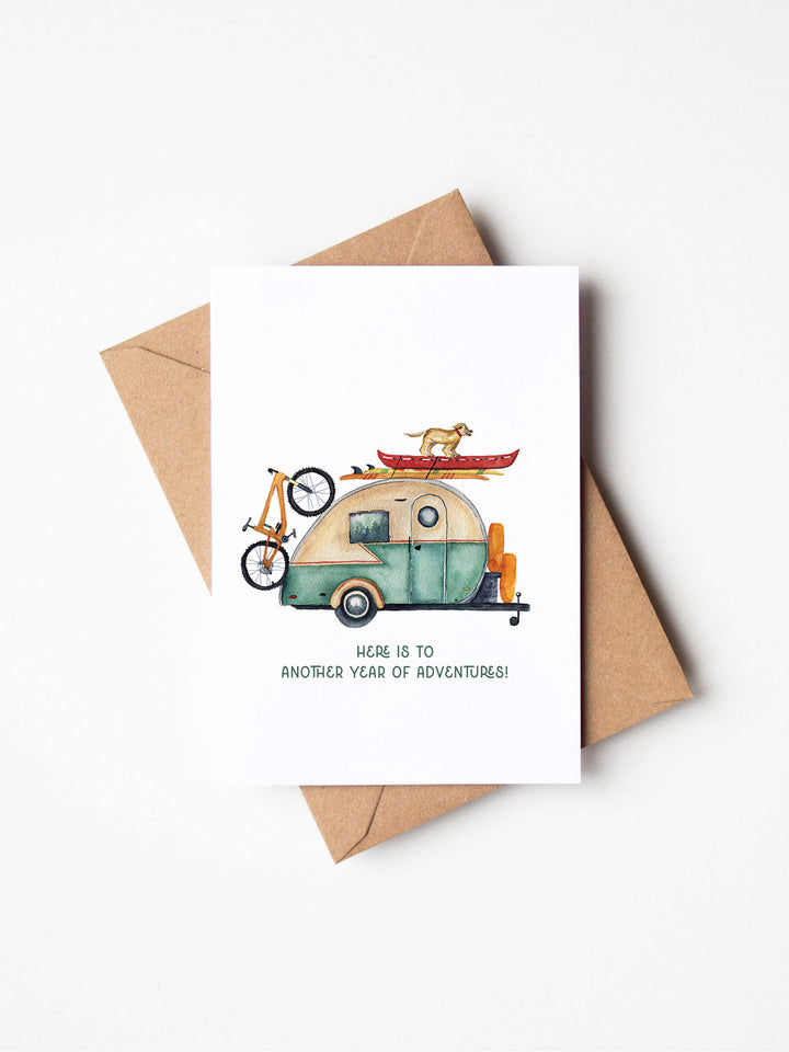 an adventure birthday card with an image of a camper and a bicycle