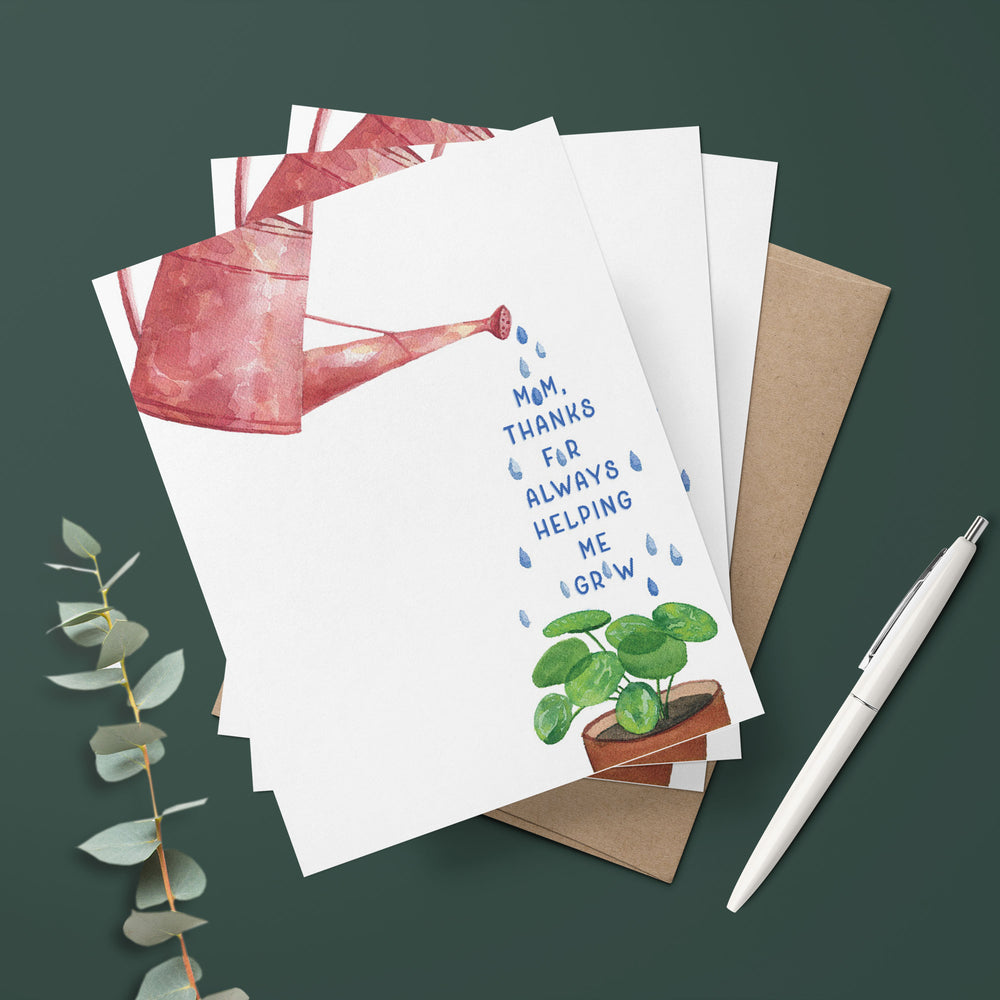 a stack of mothers day cards with a plant