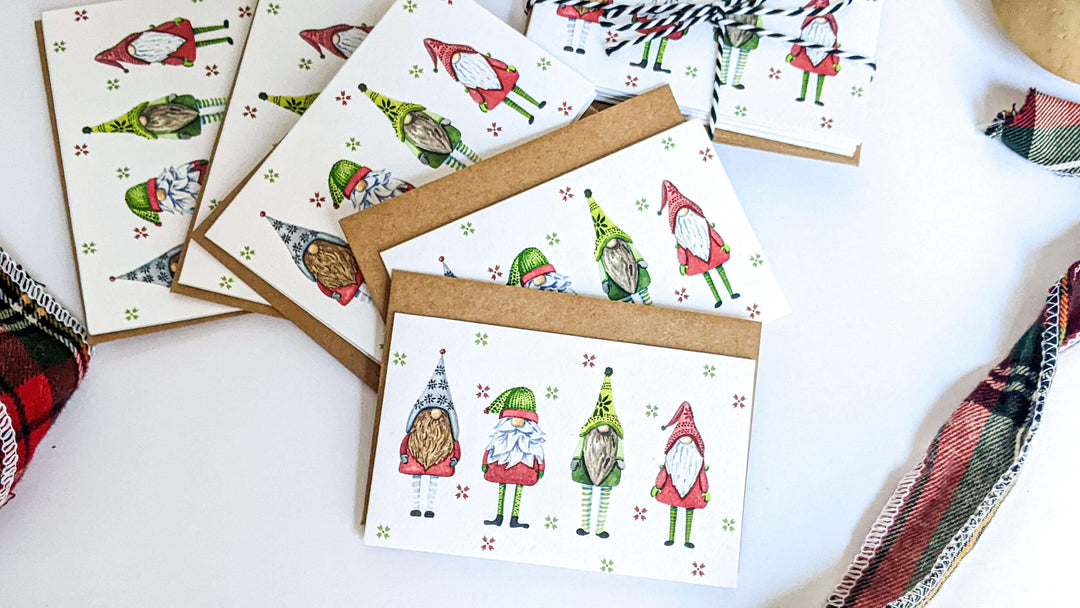 a pile of christmas cards with festive gnomes