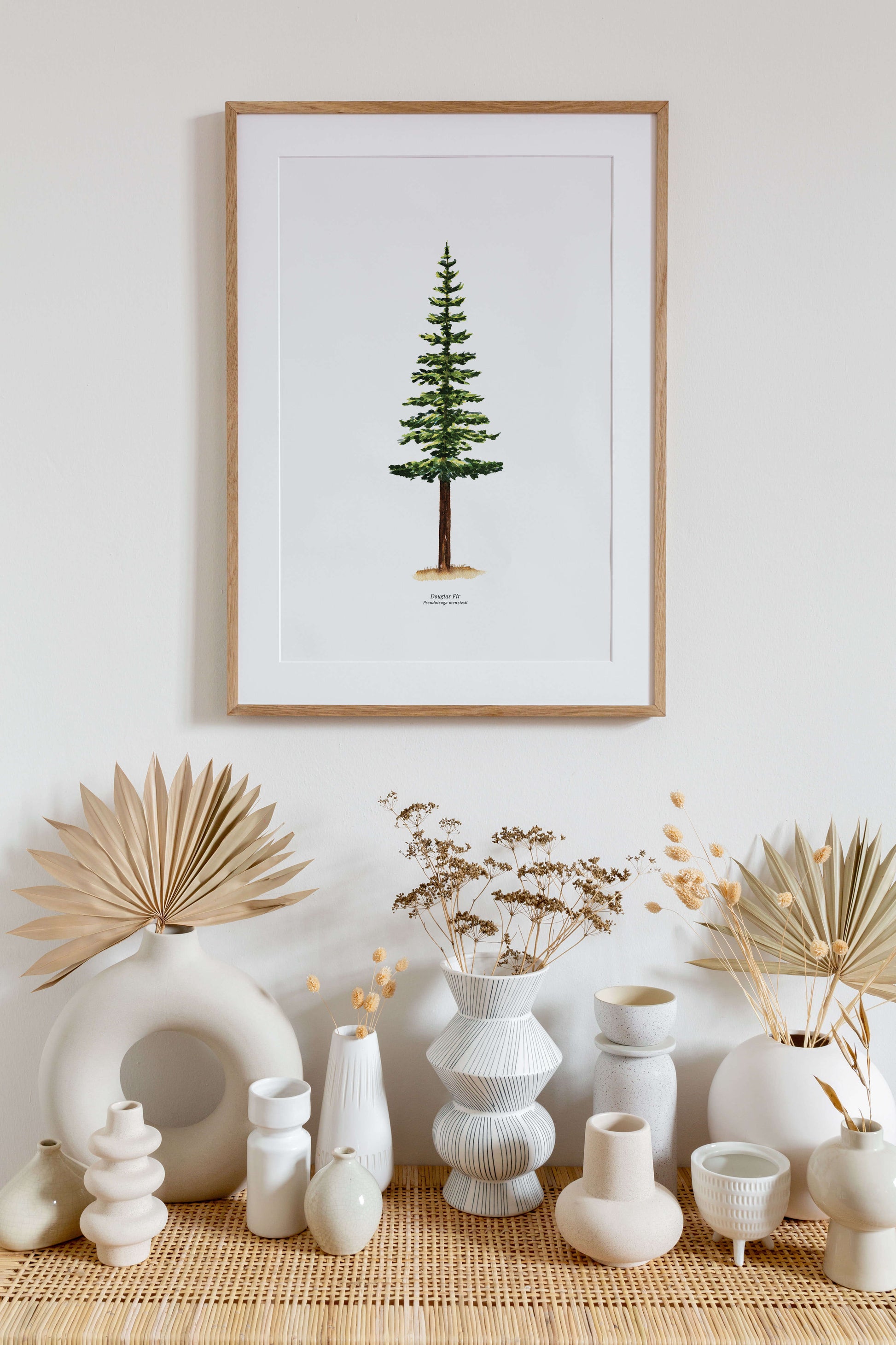 a framed print of a pine tree on a wall in a living space