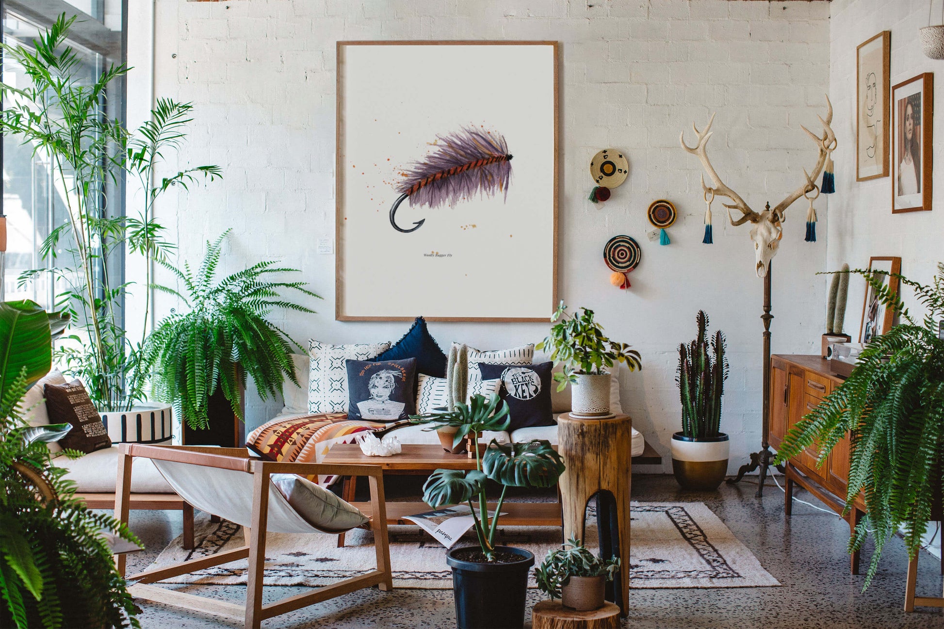 a living room filled with lots of plants and furniture and fishing wall art