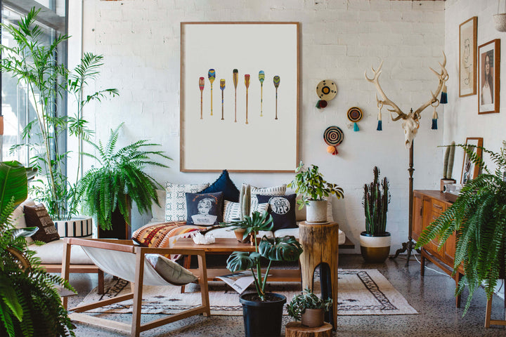 a living room filled with lots of plants and adventure decor 