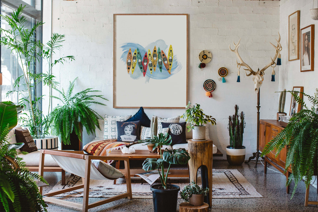 a maximalist living room with outdoorsy art work 