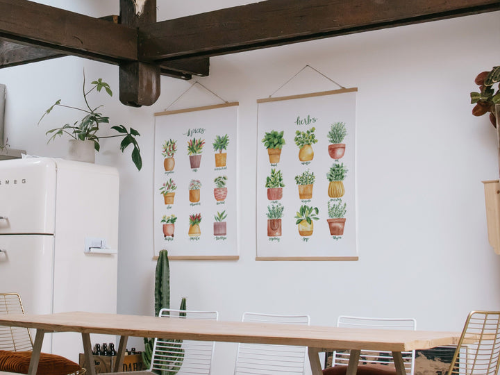 a kitchen with a refrigerator and a table with chairs and kitchen decor art