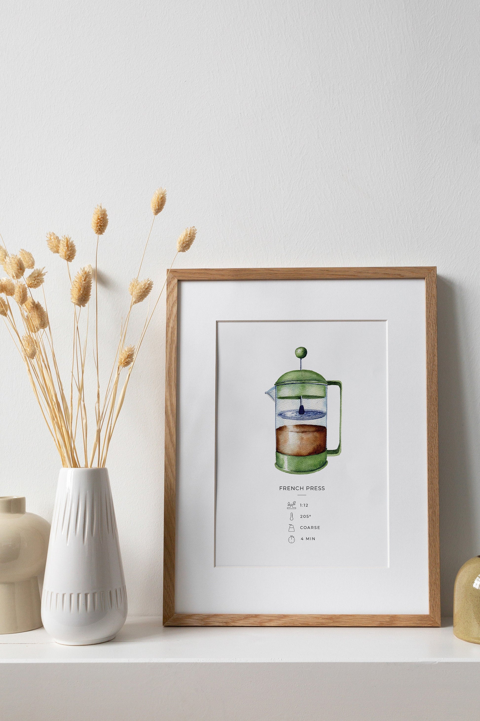 a framed picture of a french press drawing on a shelf